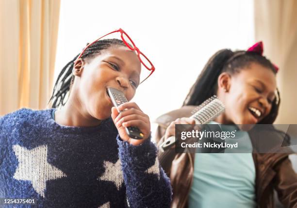 having fun at home - singing duet stock pictures, royalty-free photos & images