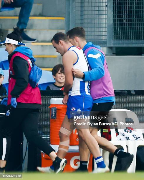 Jack Mahony of the Kangaroos leaves the field injured during the 2023 AFL Round 09 match between the North Melbourne Kangaroos and the Port Adelaide...