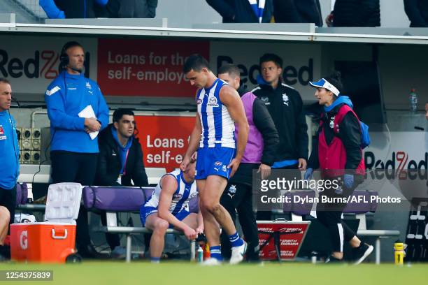 Luke Davies-Uniacke of the Kangaroos leaves the field injured during the 2023 AFL Round 09 match between the North Melbourne Kangaroos and the Port...