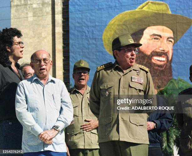 The minister of the Revolutionary Armed Forces of Cuba, Raul Castro , stands with Abel Prieto the minister of culture and Jose Ramon Machado in...