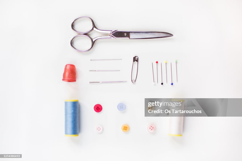 Sewing items knolling on white background