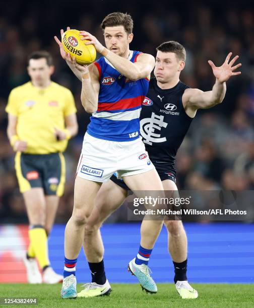 Taylor Duryea of the Bulldogs and Sam Walsh of the Blues in action during the 2023 AFL Round 09 match between the Carlton Blues and the Western...