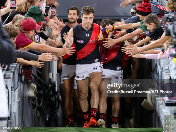 Zach Merrett of the Bombers leads the team out during the 2023 AFL Round 09 match between the Brisbane Lions and the Essendon Bombers at The Gabba on...