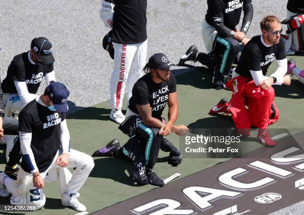 Lewis Hamilton of Great Britain and Mercedes GP, Pierre Gasly of France and Scuderia AlphaTauri and Sebastian Vettel of Germany and Ferrari take a...