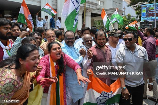 Congress supporters celebrate the party's victory in the Karnataka state legislative assembly election in front of the Karnataka Pradesh Congress...