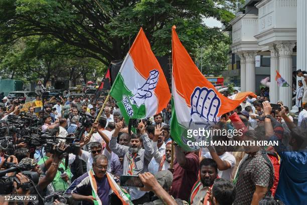 Congress supporters celebrate the party's victory in the Karnataka state legislative assembly election in front of the Karnataka Pradesh Congress...