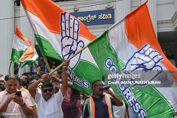 Congress supporters celebrate the party's victory in the Karnataka state legislative assembly election in front of the Karnataka Pradesh Congress...