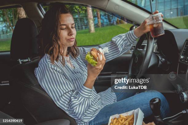 tasty take out brunch - drinking soda in car stock pictures, royalty-free photos & images
