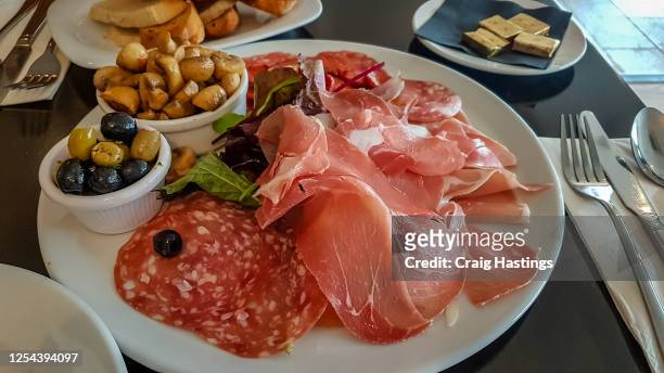 spanish meat selection platter, olives and mushrooms. traditional spanish and italian feast - spanish food stock pictures, royalty-free photos & images