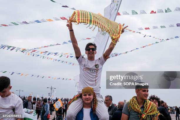 Young man holds a green, yellow and red scarf representing the Kurds during the rally. The Greens and Left Future Party , which announced that it...