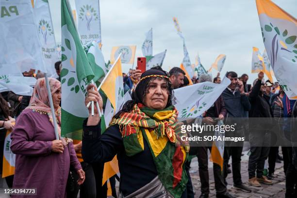 Woman waves the Green Left Party flag during the rally. The Greens and Left Future Party , which announced that it would support Kemal Klçdarolu in...