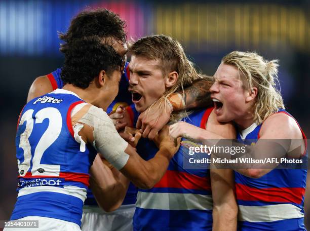 Arthur Jones, Bailey Smith and Cody Weightman of the Bulldogs celebrate during the 2023 AFL Round 09 match between the Carlton Blues and the Western...