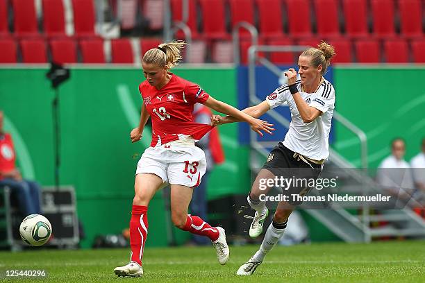 Simone Laudehr of Germany fights for the bal with Ana Crnogorcevic of Switzerland during the UEFA Women's EURO Qualifier match between Germany and...