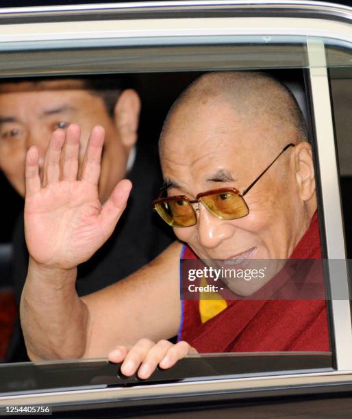 Tibetan spiritual leader the Dalai Lama reacts to wellwishers upon his arrival at the Narita Airport in Narita city in Chiba prefecture, suburban...