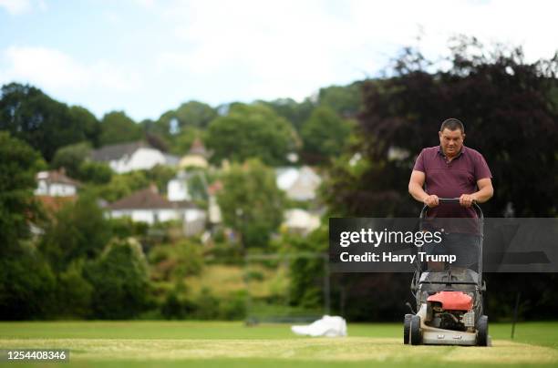 Groundstaff work on the pitch at Uplyme & Lyme Regis Cricket Club prior to the club taking part in a training session in a group of 6 on July 05,...