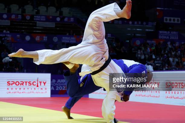 France's Teddy Riner and Tajikistan's Temur Rakhimov compete during the men's +100Kg semi-final bout at the World Judo Championship in Doha on May...