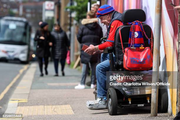 Detailed view of the bag and scarf of a Crystal Palace fan hanging from the back of their mobility scooter ahead of the Premier League match between...