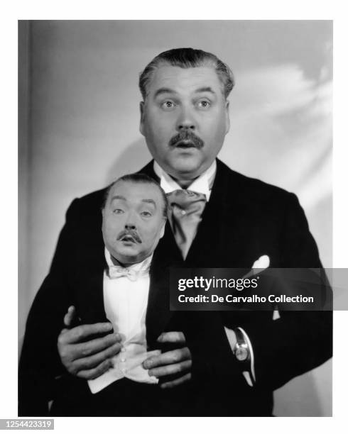 Actor Nigel Bruce as 'Willie Wynton', holding a puppet that bears resemblance to himself in a publicity shot from the movie 'The Last Of Mrs Cheyney'...