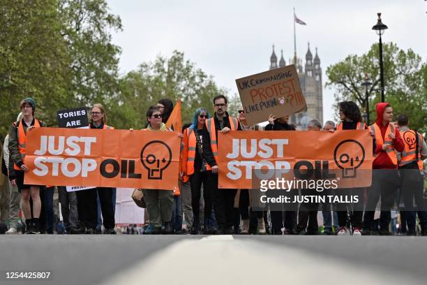 Just Stop Oil climate activists slow march in central London on May 13, 2023 as part of their campaign calling on the UK government to end approval...