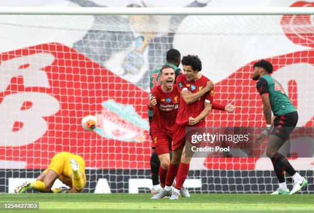 Curtis Jones of Liverpool celebrates with teammate Jordan Henderson after scoring his team's second goal during the Premier League match between...