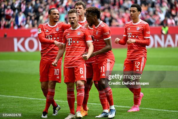 Joshua Kimmich of Bayern Muenchen celebrates after scoring his team's second goal with teammates during the Bundesliga match between FC Bayern...