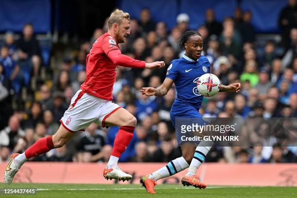 Nottingham Forest's English defender Joe Worrall challenges Chelsea's English midfielder Raheem Sterling during the English Premier League football...