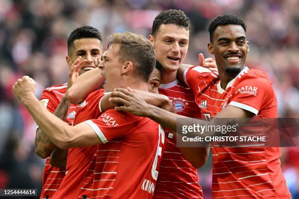 Bayern Munich's German midfielder Serge Gnabry is congratulated by Bayern Munich's Portuguese defender Joao Cancelo, Bayern Munich's German...