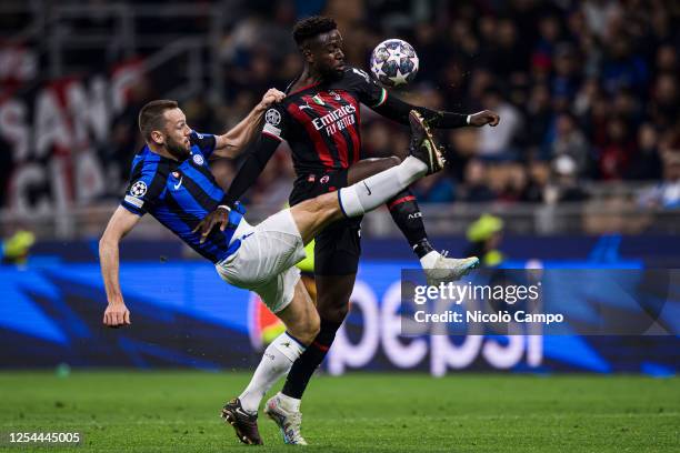 Divock Origi of AC Milan competes for the ball with Stefan de Vrij of FC Internazionale during the UEFA Champions League semifinal first leg football...