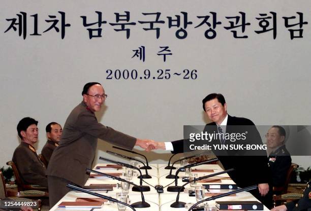 North Korean, People's Armed Forces Minister, Kim Il-chol and his South Korean counterpart, Cho Seong-tae, before their first meeting shakes hands in...