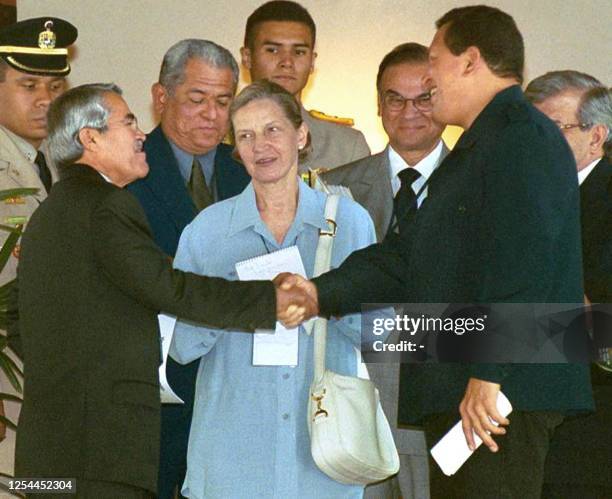Saudi Arabian Oil Minister Ali Bin Ibrahim Al Nahimi shakes hands with Venezuelan President Hugo Chavez 26 September, 2000. The minister is in...