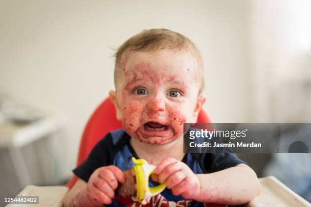 little messy painted face baby boy starting crying - baby paint stock pictures, royalty-free photos & images