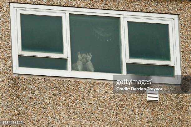 Child is seen looking out a window of the Flemington Towers Government Housing complex on July 06, 2020 in Melbourne, Australia. Nine public housing...