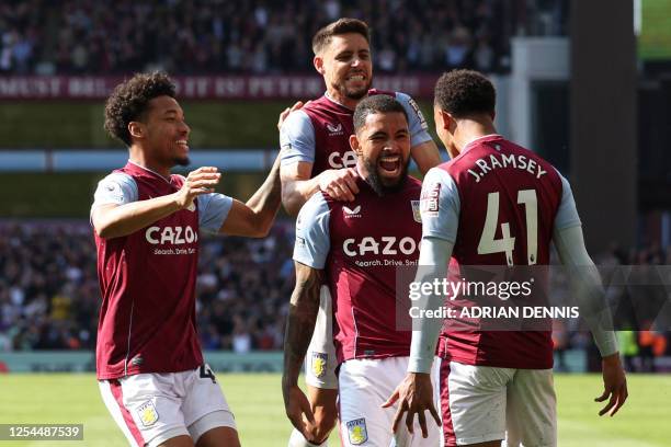 Aston Villa's Brazilian midfielder Douglas Luiz celebrates with Aston Villa's English midfielder Jacob Ramsey after scoring his team's second goal...