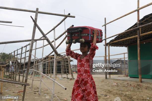 Child carries a luggage as the Bangladeshi coastal people leave their homes to take shelter due to the expected impact of cyclone Mocha on May 13,...