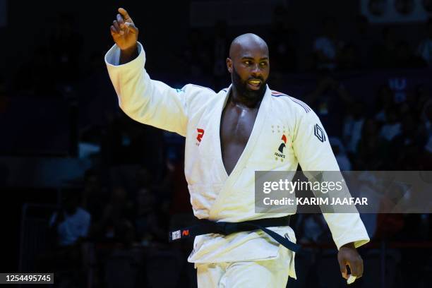 France's Teddy Riner celebrates his win against Russia's Inal Tasoev in the men's +100Kg final bout at the World Judo Championship in Doha on May 13,...