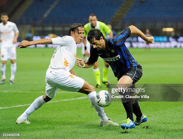 Rodrigo Taddei of AS Roma and Diego Milito of FC Inter Milan battle for the ball during the Serie A match between FC Internazionale Milano and AS...