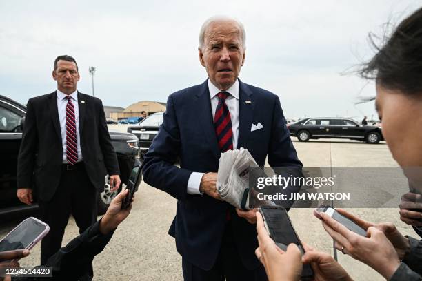 President Joe Biden speaks to reporters about the continued debt ceiling negotiations before boarding Air Force One as he departs from Joint Base...