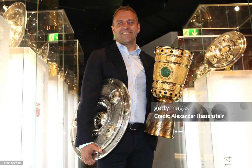 Hans-Dieter Flick Hands Over Championship And DFB Cup Trophy To FCB Erlebniswelt