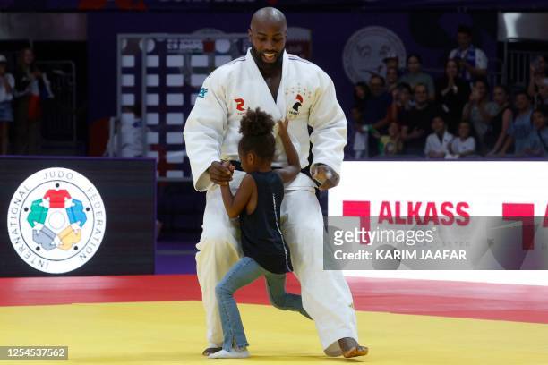 France's Teddy Riner plays with his daughter after his win against Russia's Inal Tasoev in the men's +100Kg final bout at the World Judo Championship...