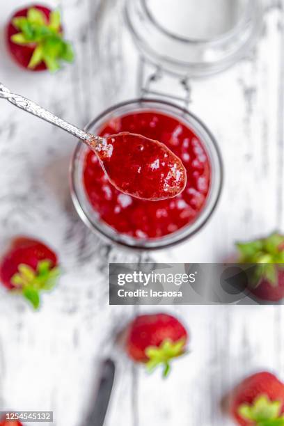 glass of homemade strawberry jam and strawberries - jam jar stock pictures, royalty-free photos & images