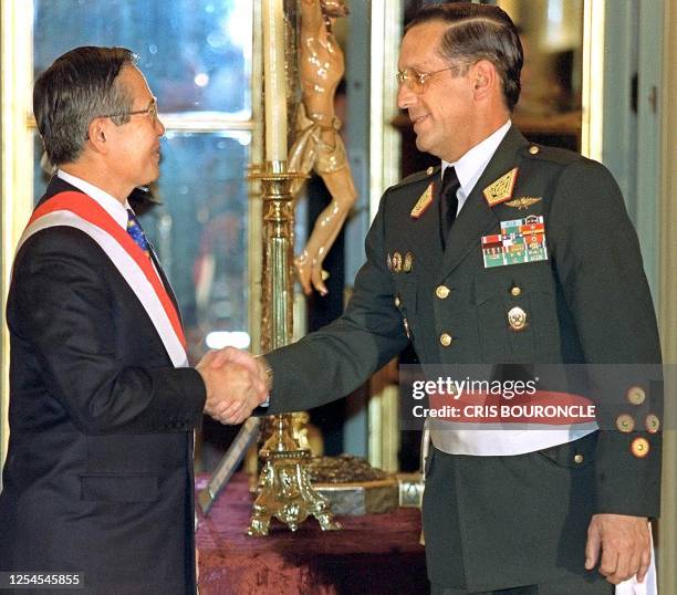 Peruvian President Alberto Fujimori congratulates the Police General Fernando Dianderas after taking oath as a new Minister of Interior during the...