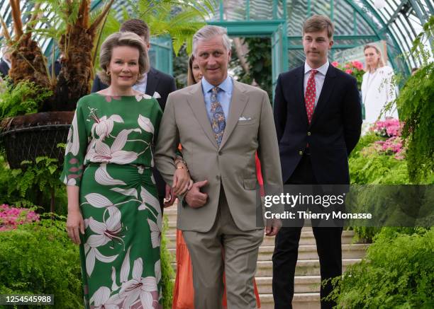 Queen Mathilde d'Udekem d'Acoz , the King Philippe of Belgium and the Prince Emmanuel walk in the green house during a garden party in the Palace of...