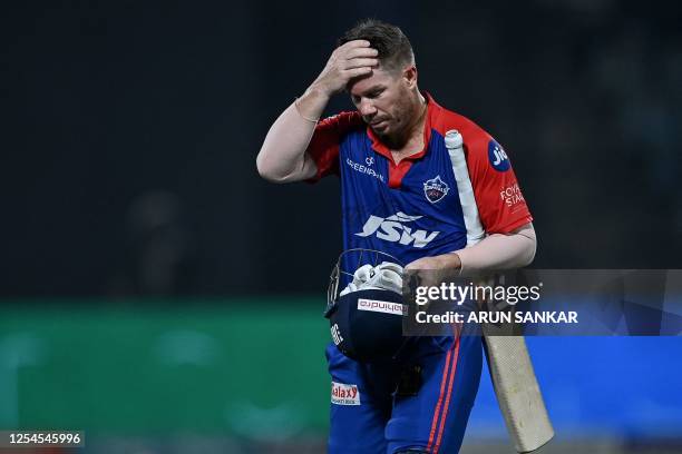 Delhi Capitals' David Warner gestures as he walks back to the pavilion after his dismissal during the Indian Premier League Twenty20 cricket match...