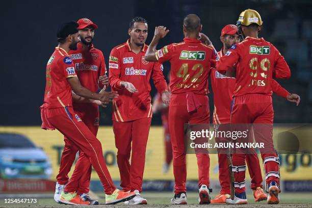 Punjab Kings' Rahul Chahar celebrates with teammates after taking the wicket of Delhi Capitals' Axar Patel during the Indian Premier League Twenty20...