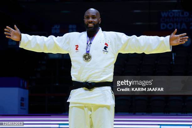 France's Teddy Riner poses with his gold medal after his win against Russia's Inal Tasoev in the men's +100Kg final bout at the World Judo...