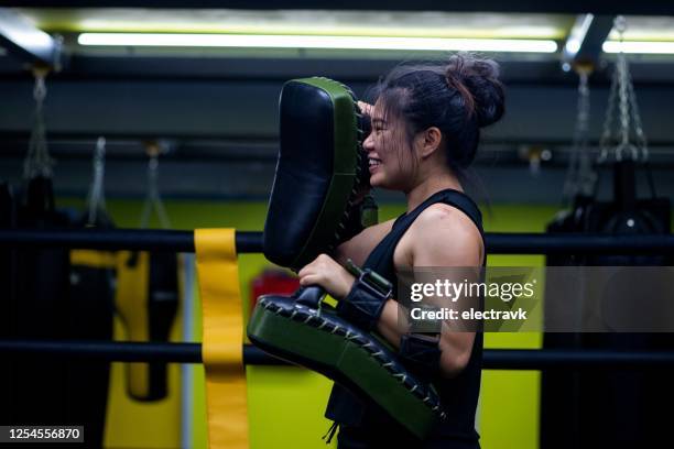 martial arts instructor training her athlete - muay thai stock pictures, royalty-free photos & images