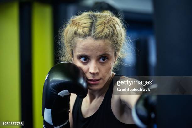 woman practicing martial arts - muay thai stock pictures, royalty-free photos & images