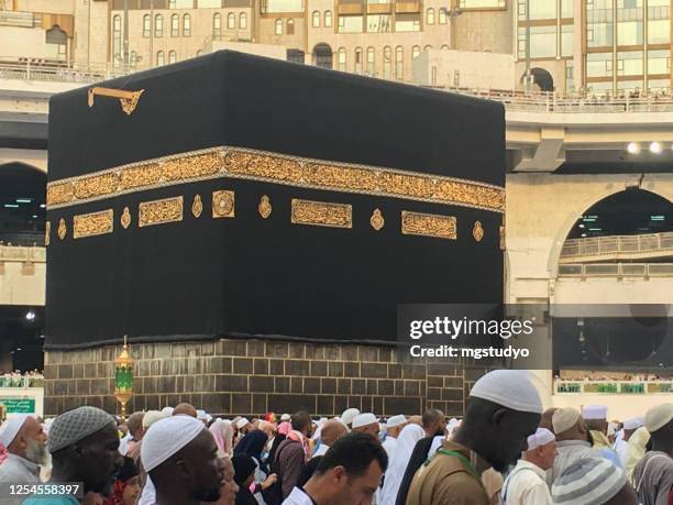 people walking around holy kaaba - kaaba stock pictures, royalty-free photos & images