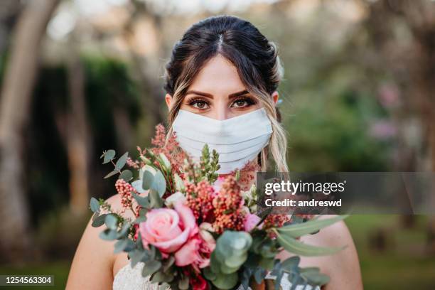 bride smiling behind the mask - quarantine wedding stock pictures, royalty-free photos & images