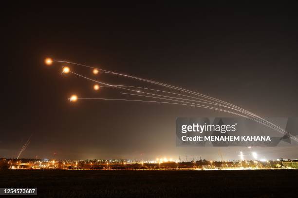 Israel's Iron Dome air defence system intercepts rockets launched from Gaza City on May 13 over the southern city of Sderot. Israeli air strikes...